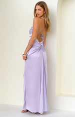 Side view of a lilac satin maxi dress with criss-cross tie-back straps and ruched detail on the lower back
