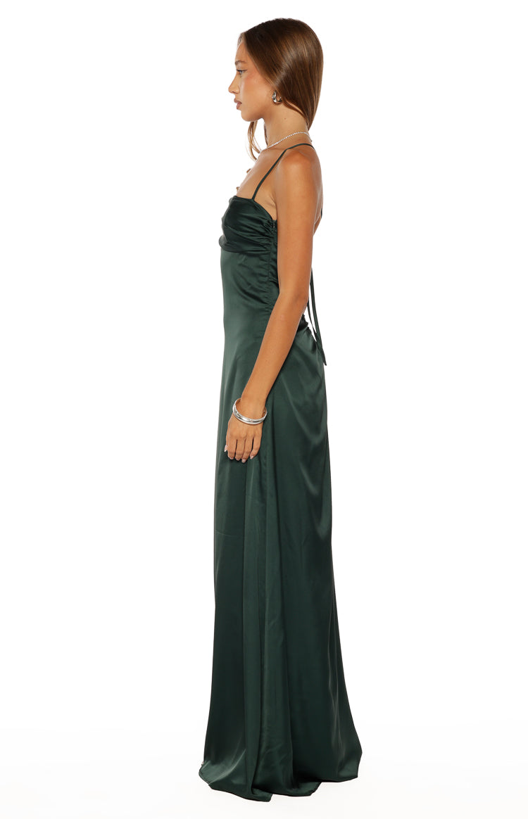 Side view of an emerald satin maxi dress with ruched bodice, spaghetti straps, and tie-back detail