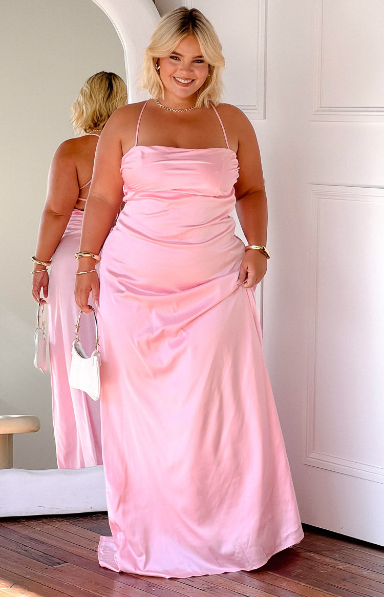 Pink satin maxi dress with a straight neckline, delicate spaghetti straps, and a draped maxi skirt