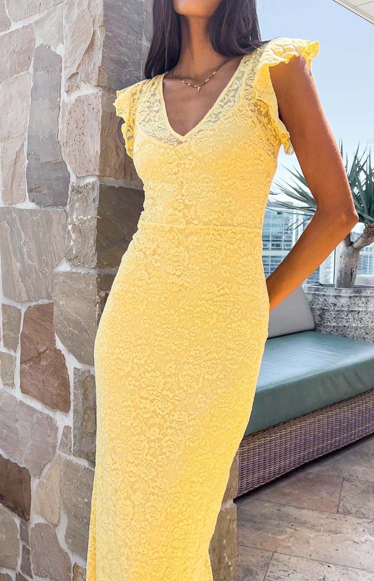 Close-up of a yellow lace maxi dress with a V-neckline and ruffled cap sleeves