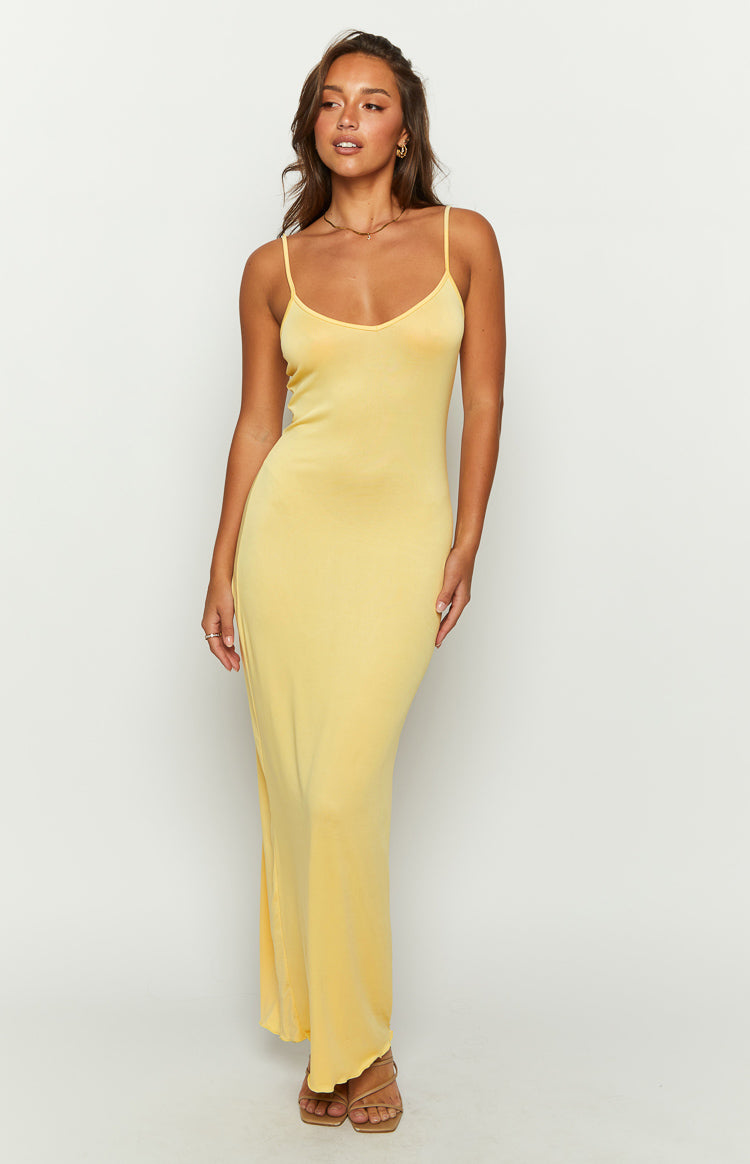 Front view of a yellow V-neck maxi dress with thin spaghetti straps and a side slit