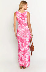 Rear view of a fitted pink floral maxi dress with a scoop back and ruched side detail