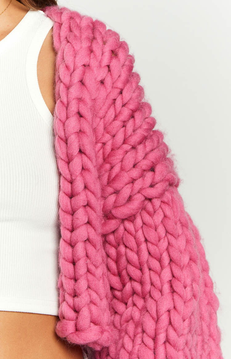 Close-up of the blush pink chunky knit cardigan sleeve, showing the thick woven texture