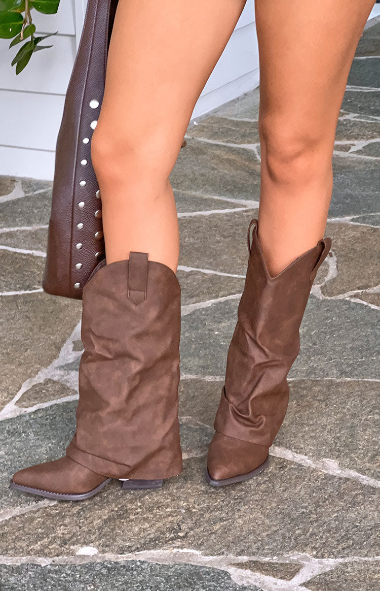 Chocolate suedette boots with one shaft folded down to reveal the slouchy design, and the other pulled up, featuring pointed