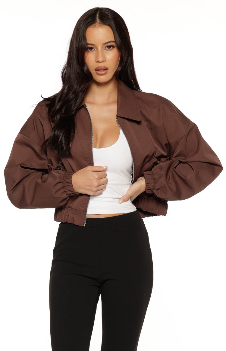 Front view of a chocolate brown bomber jacket with an open zipper, showing the collar and elasticated cuffs and hem