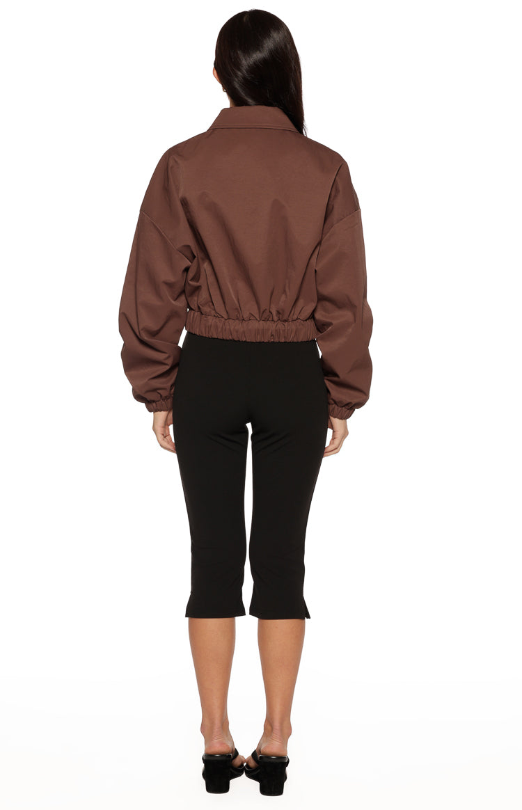 Rear view of the chocolate bomber jacket showing the relaxed fit, elasticated hem, and cuffed sleeves