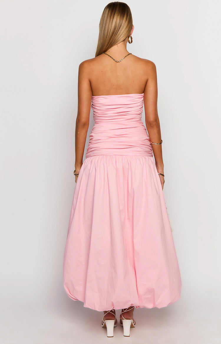 Rear view of a pink strapless maxi dress with a ruched bodice and a voluminous bubble hem skirt