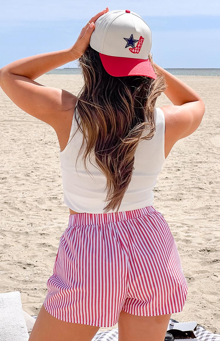 Back view of red and white vertical striped boxer shorts featuring a gathered elasticated waistband and relaxed, flowy fit