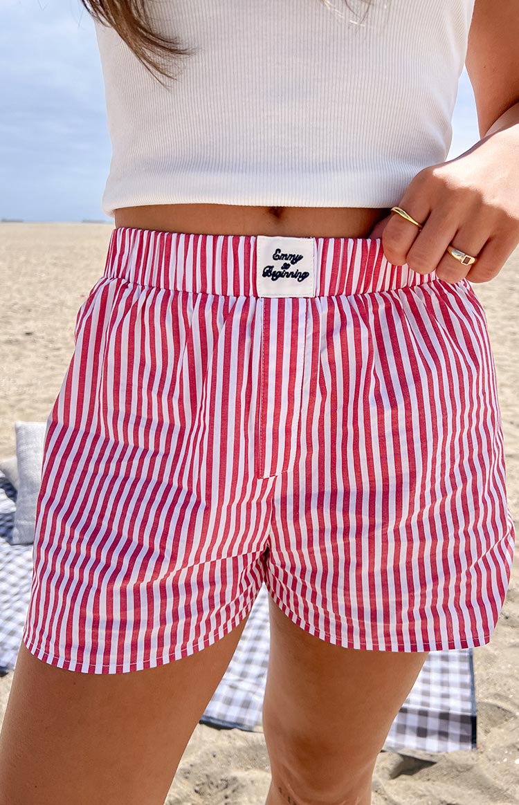 Red and white striped boxer shorts with elasticated waist, embroidered brand label, and curved hem