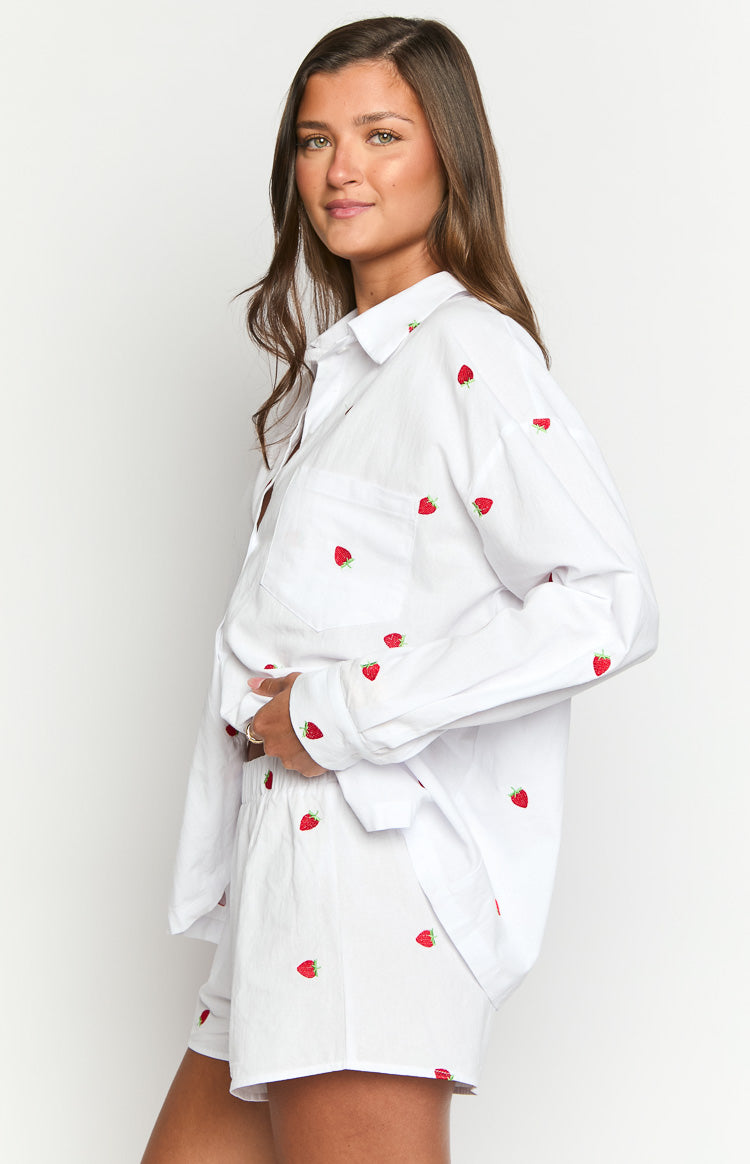 Side view of white boxer shorts with all-over red strawberry embroidery and a visible elasticated waistband