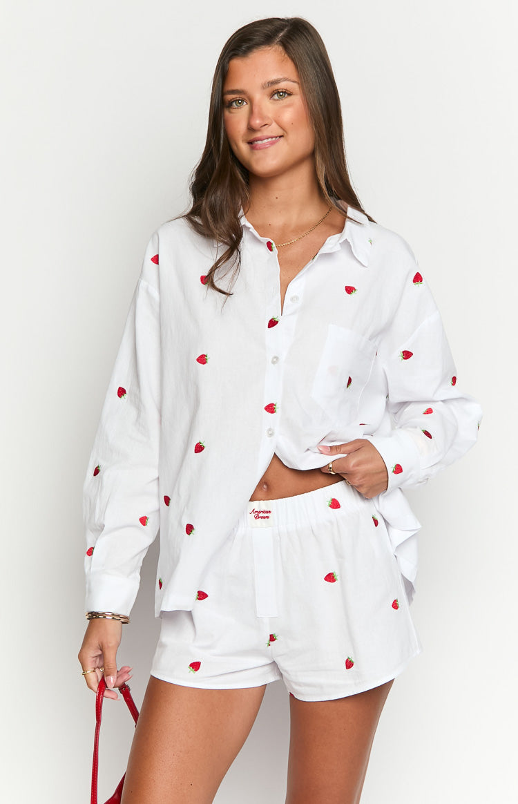 Front view of white boxer shorts with all-over red strawberry embroidery and an elasticated waist