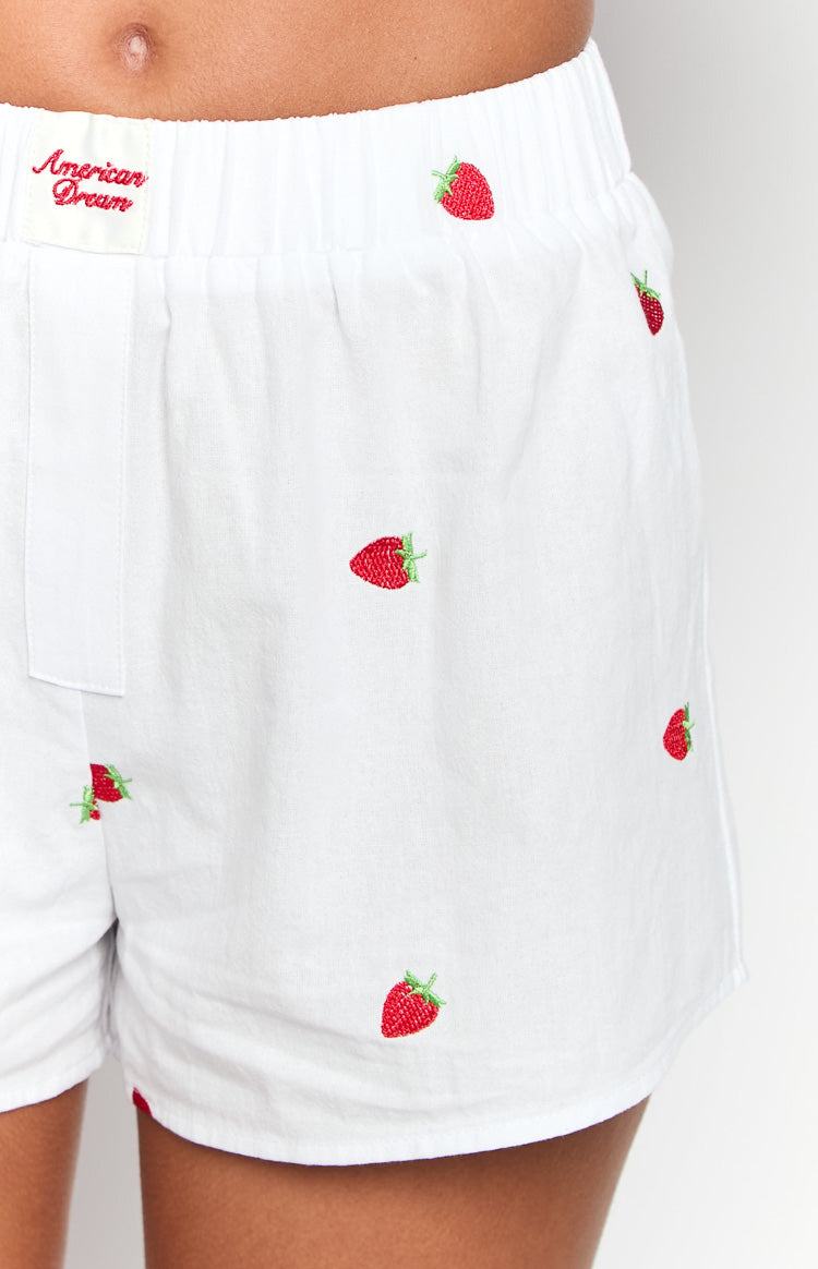 Detail shot of the white boxer shorts showing red strawberry embroidery, elasticated waistband, and 'American Dream' label