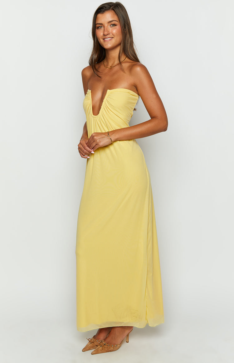 Side view of a yellow strapless maxi dress with a deep V-plunge ruched neckline