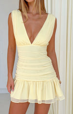 Yellow mini dress with a deep V-neckline, ruched bodice and skirt, and a ruffled hem
