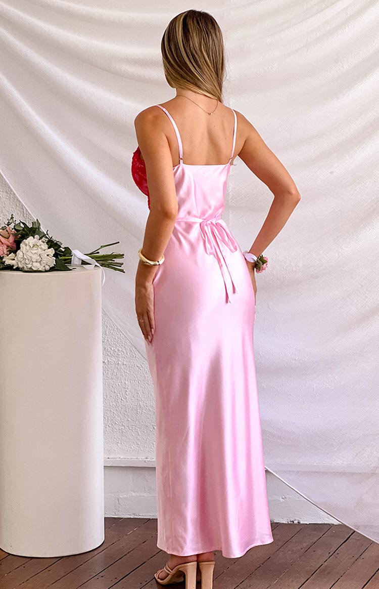 Rear view of a pink satin maxi dress with thin spaghetti straps and a tie-back waist detail