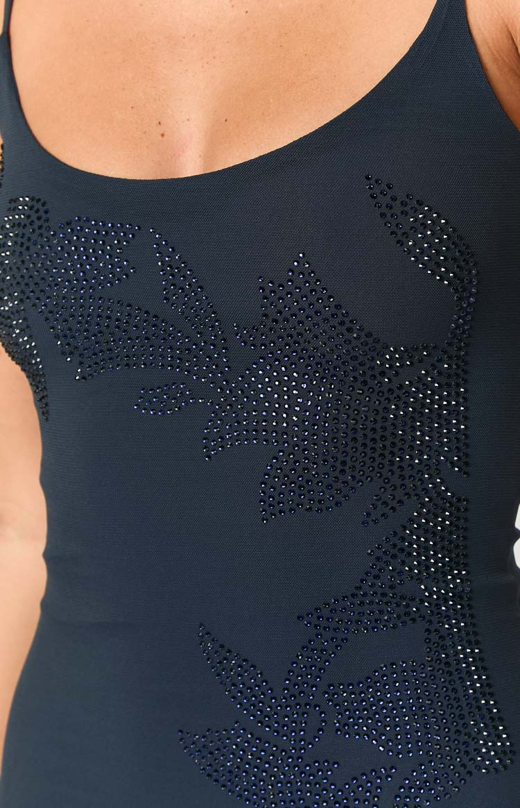Close-up of the navy sequin pattern on the bodice of the mini dress, forming a leaf-like design