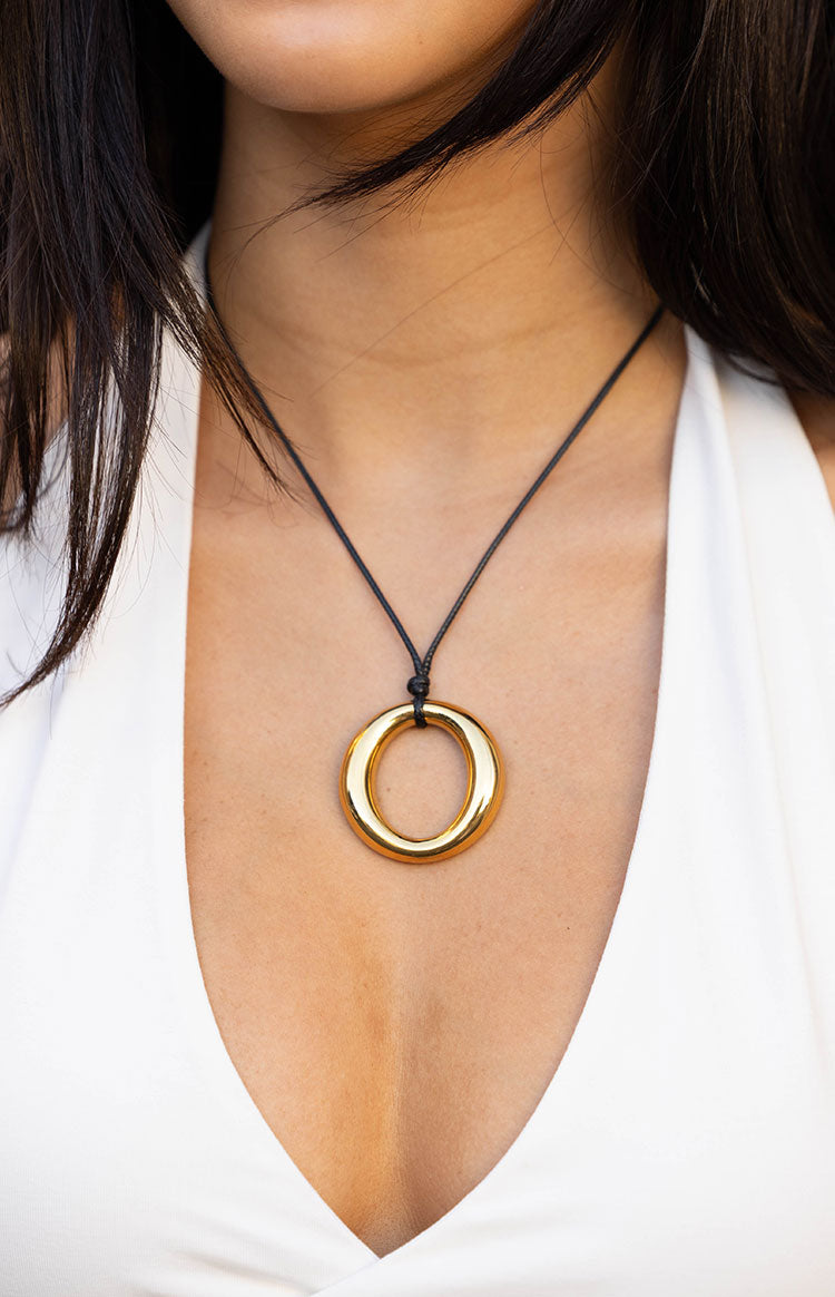 Beginning Boutique Brinley Gold and Black Pendant Necklace gold ring pendant on a black cord