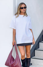 Black mini skirt with small white polka dots and a straight hemline