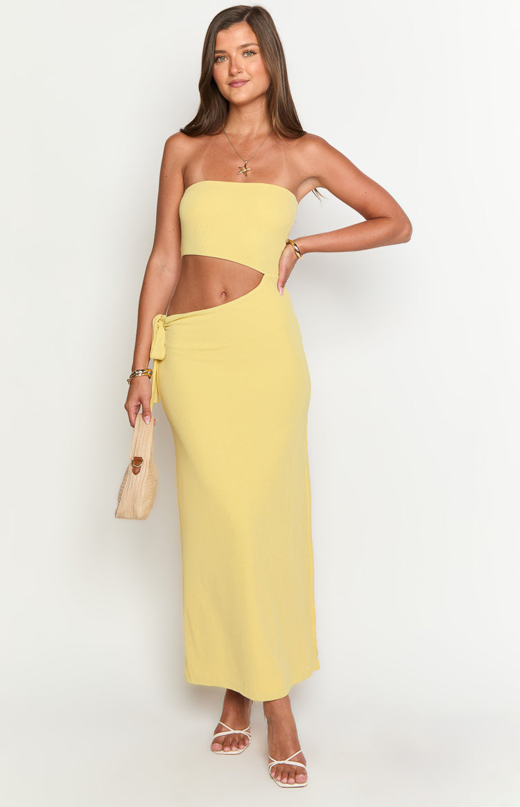 Yellow strapless maxi dress featuring a side cut-out at the waist and a decorative tie detail