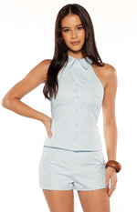 Front view of light blue woven mini shorts with a relaxed fit and simple design