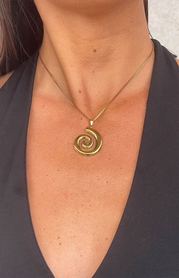 Beginning Boutique Caledonia Gold Swirl Necklace gold box chain necklace with a large polished swirl pendant