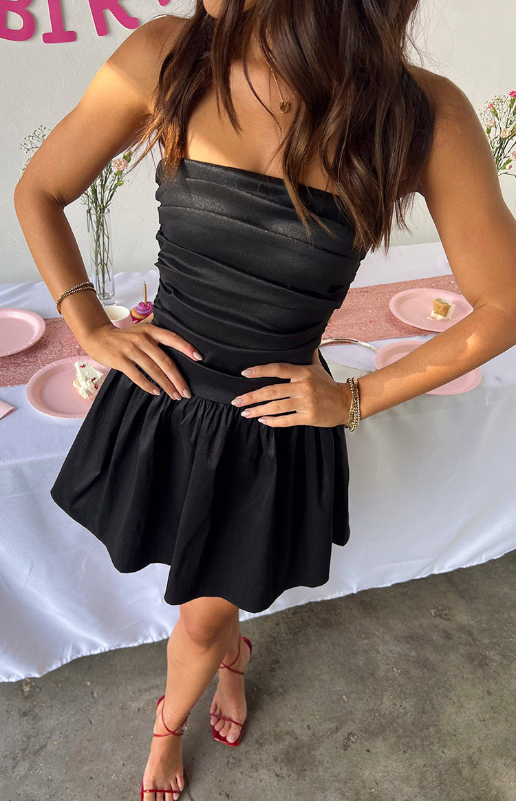 Black strapless mini dress with a ruched, fitted bodice and a voluminous gathered skirt