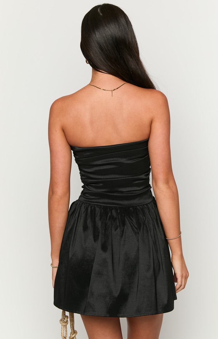 Rear view of a black strapless mini dress with a ruched bodice and gathered skirt