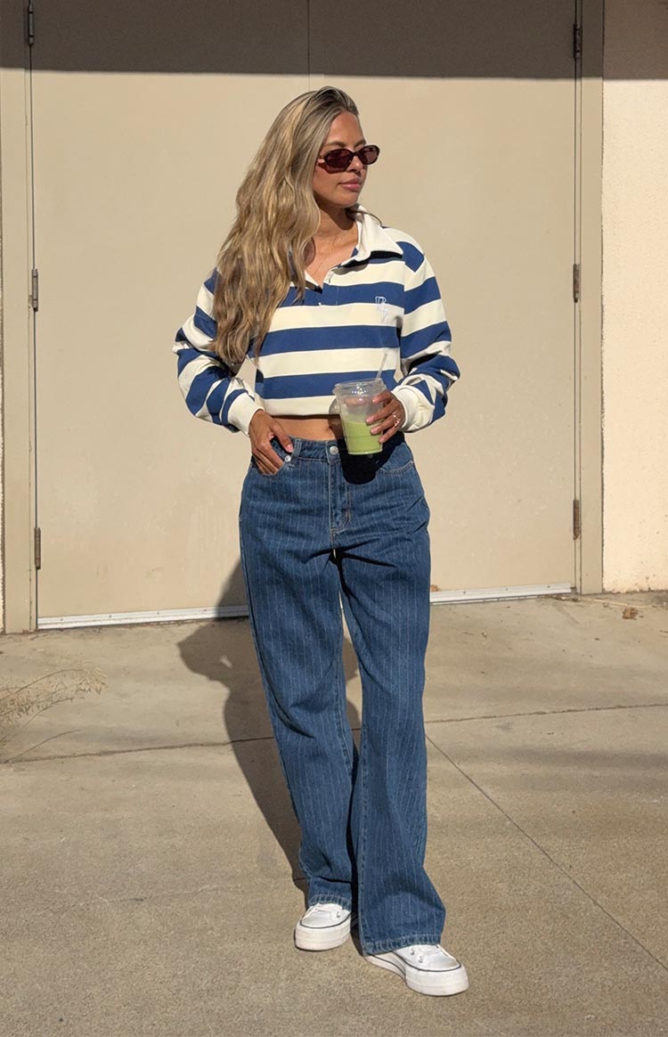 Full length view of mid wash pinstripe slouchy jeans with a relaxed wide-leg fit