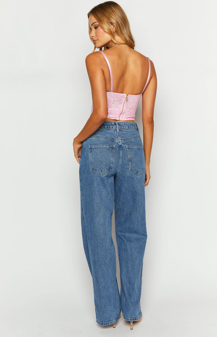 Rear view of mid wash slouchy jeans showing the back pockets and relaxed wide leg fit