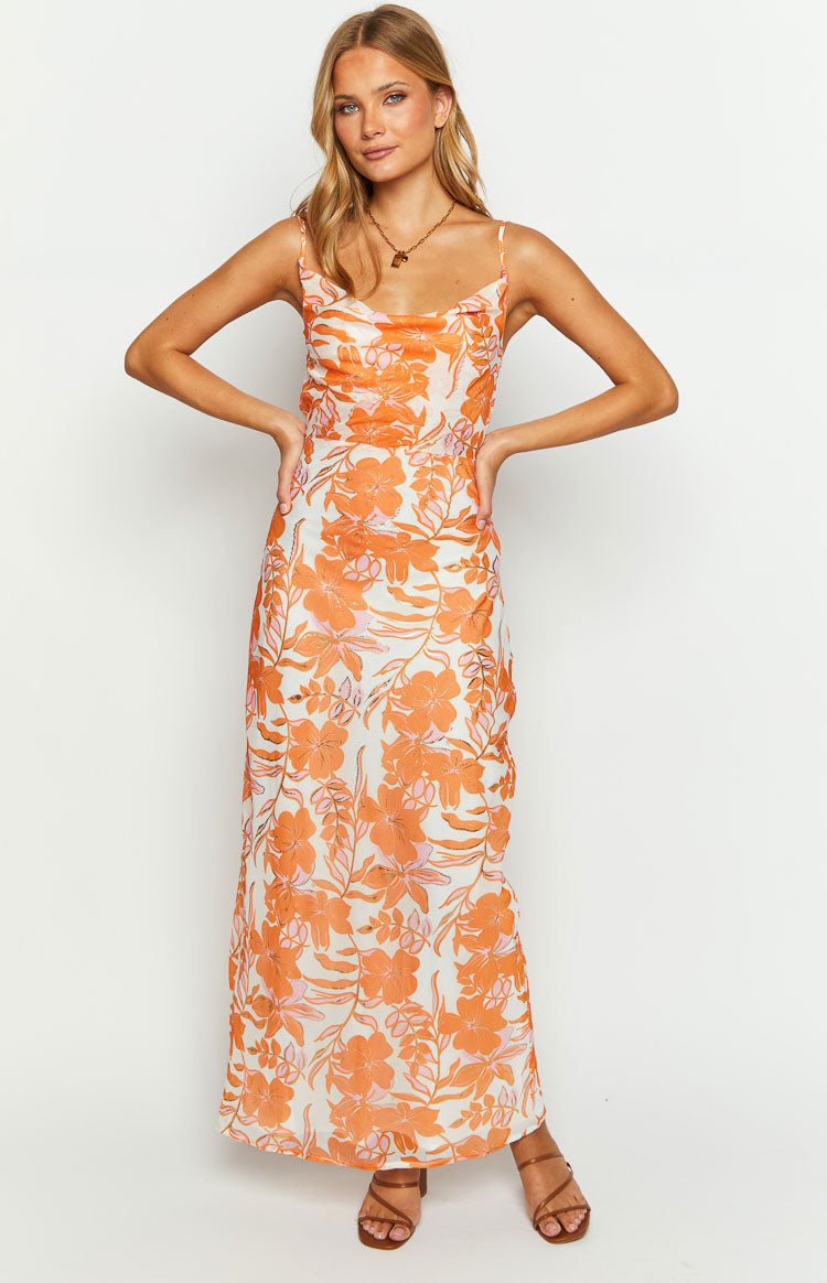 Front view of an orange floral print chiffon maxi dress with a cowl neck and spaghetti straps