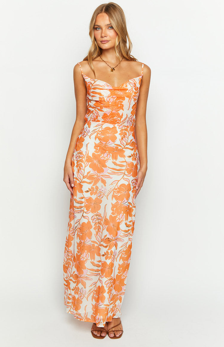 Full length view of a white chiffon maxi dress with a cowl neck and vibrant orange floral print