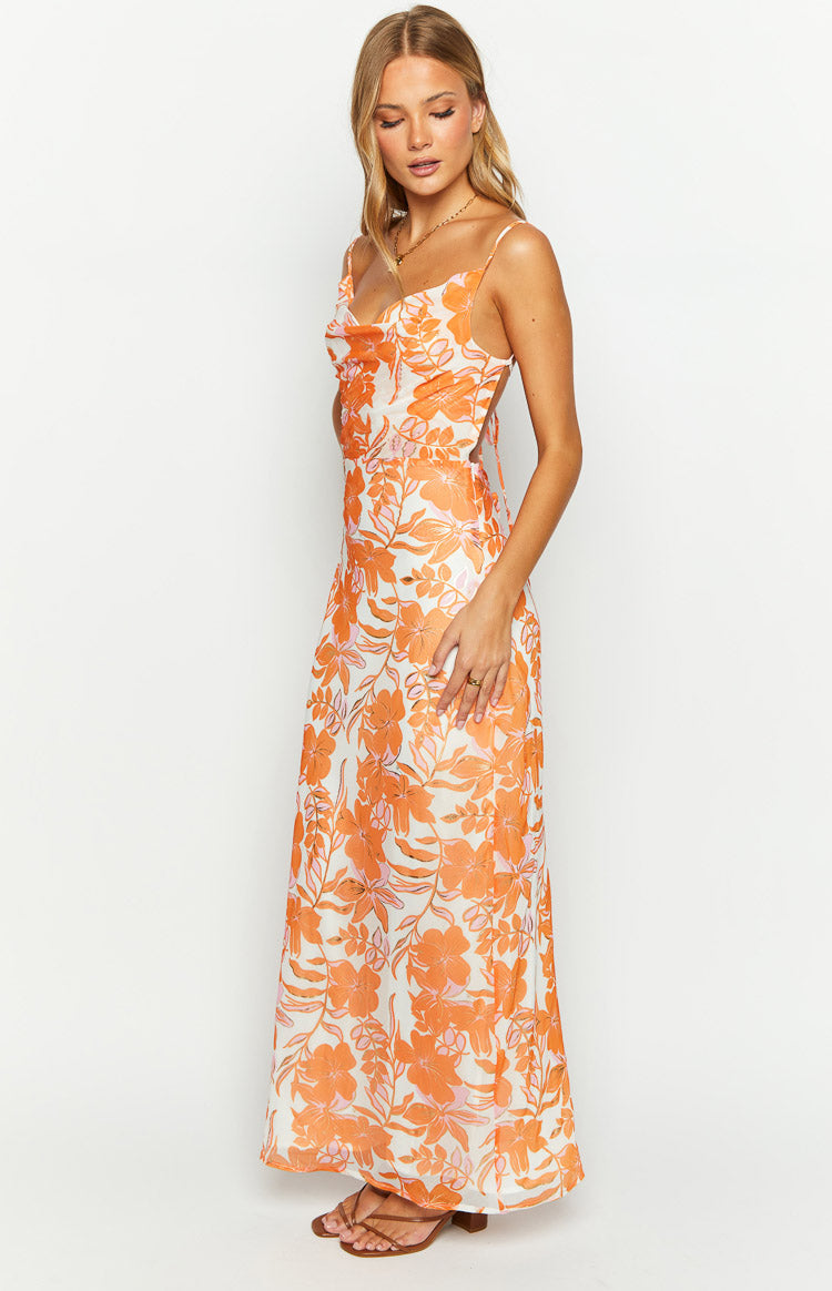 Side view of an orange floral chiffon maxi dress with a cowl neckline and open back detail