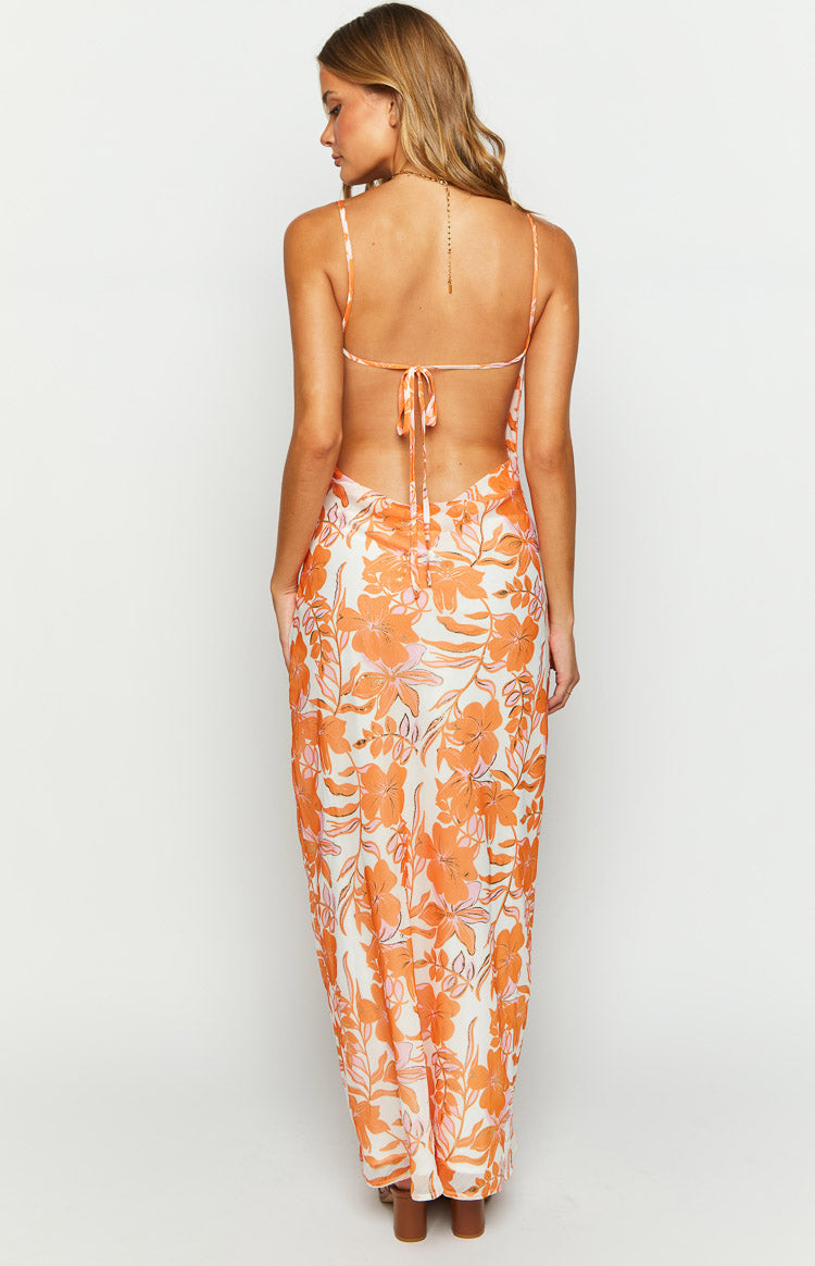 Rear view of an orange floral chiffon maxi dress with an open back and tie detail
