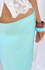 Close-up of the aqua satin midi skirt, showing the fabric's smooth texture and how it drapes at the waist