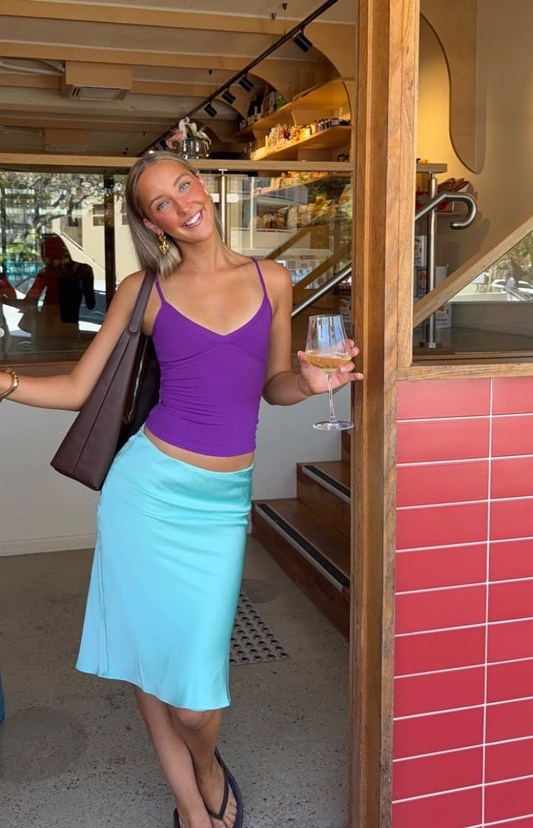 Aqua satin midi skirt with a low-rise waist and a flowing bias cut silhouette