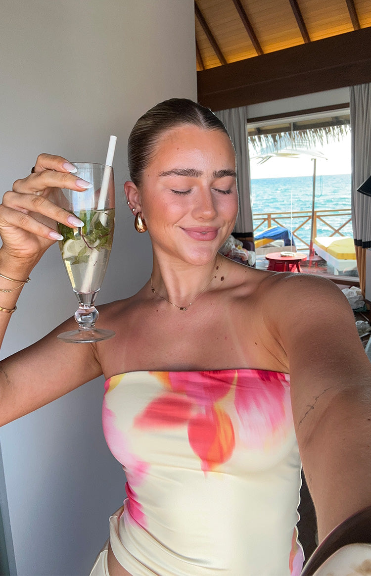 Close-up of the strapless yellow tube top with abstract pink and orange floral print