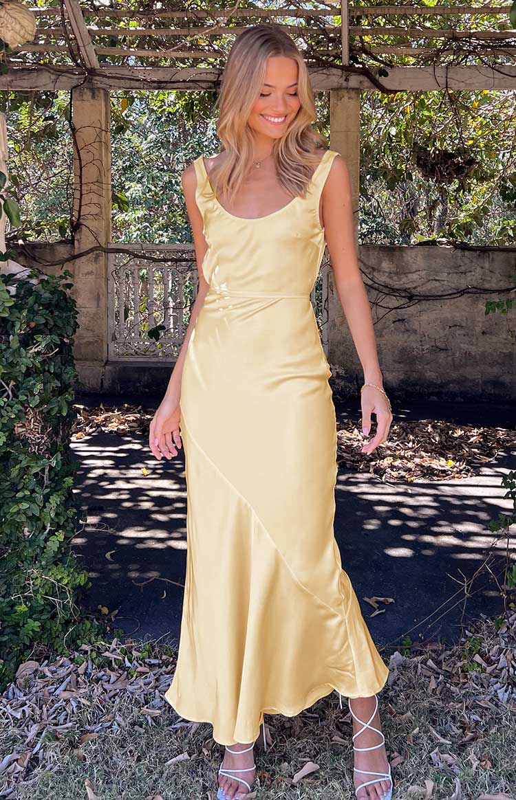 Front view of the carnation yellow satin maxi dress, showing the scoop neckline, thick shoulder straps, and subtle side ruching