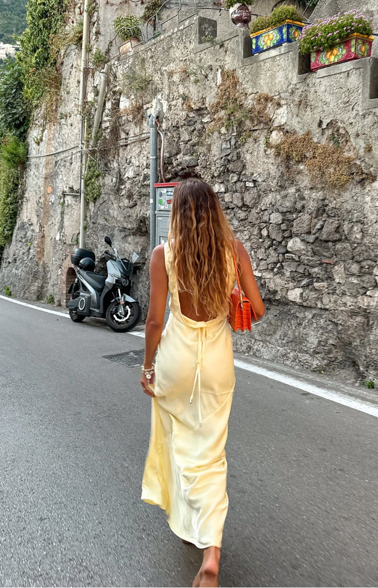 Beginning Boutique Carnation Yellow Satin Maxi Dress carnation yellow satin sleeveless maxi dress with a low scoop back and tie detail