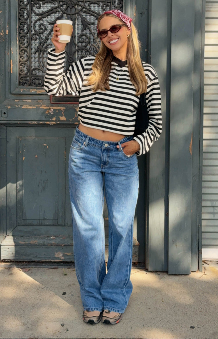 Full length mid wash blue low rise jeans with a relaxed wide leg fit