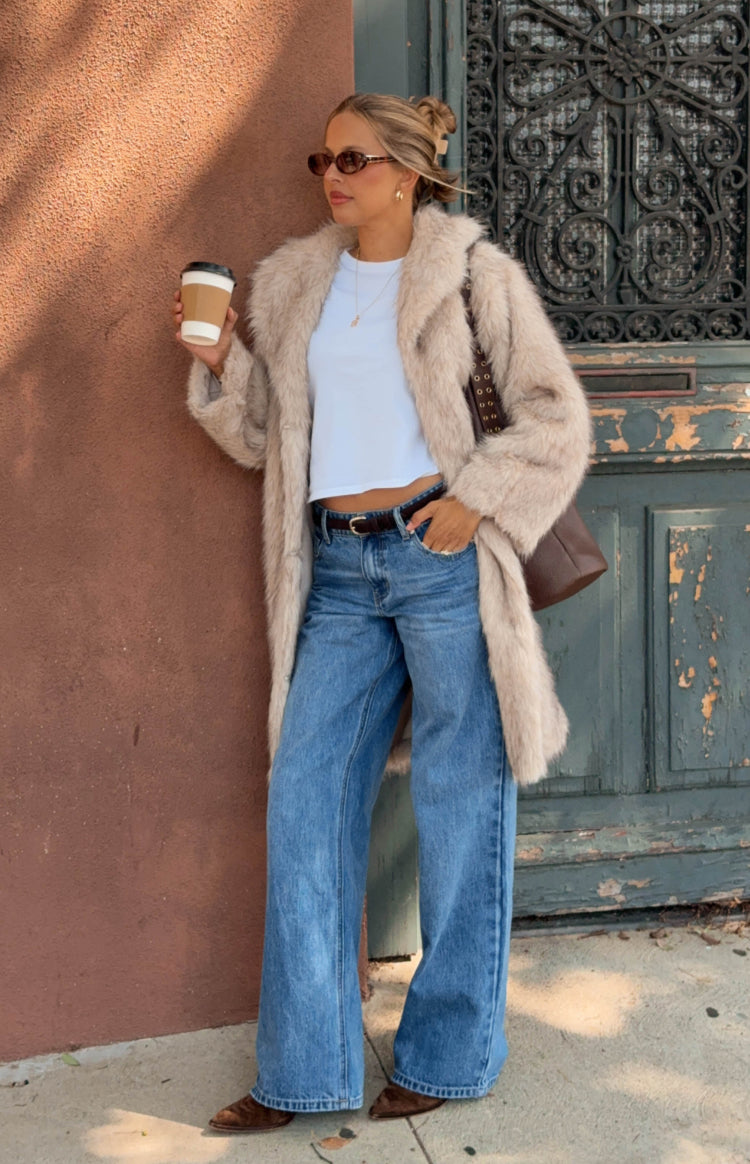 Full length view of blue mid wash low rise wide leg jeans with a relaxed fit