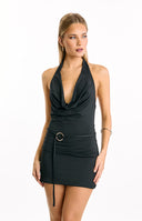 A sophisticated black mini dress with a draped cowl neckline- halter straps- and a cinched waist with a gold O-ring detail- perfect for a sleek evening look or semi-formal occasion.