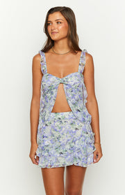 Purple floral chiffon top featuring a square neckline, ruffled straps, and a central cutout with a tie front