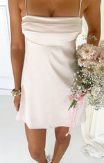 Close-up of the cream satin mini dress showing the draped bust detail and thin spaghetti straps