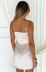 Rear view of a cream satin mini dress with a smocked back bodice and thin adjustable spaghetti straps