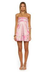 Pink satin mini dress with a straight neckline, ruched bodice, and green floral print