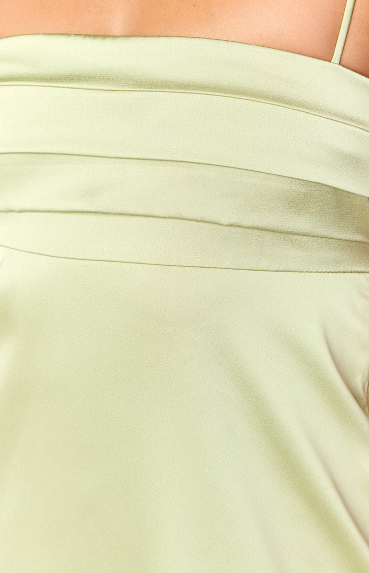 Close-up of the horizontal pleating detail on the sage mini dress with a thin spaghetti strap
