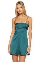 Model wearing a green teal satin slip dress with an a line silhouette ideal for a Homecoming or Semi Formal event