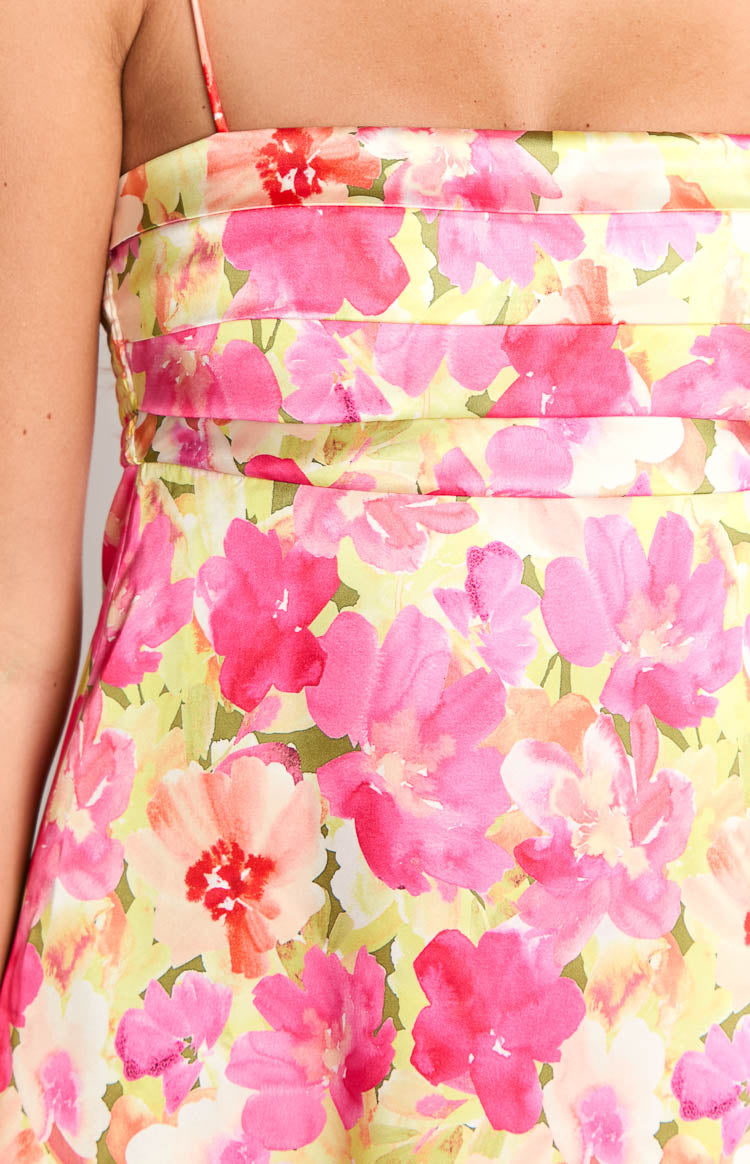 Close-up of the yellow floral print mini dress with pink and orange flowers and horizontal pleats on the bodice