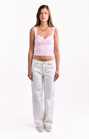 Full length front view of white low waist baggy leg jeans showing the relaxed fit and contrast stitching