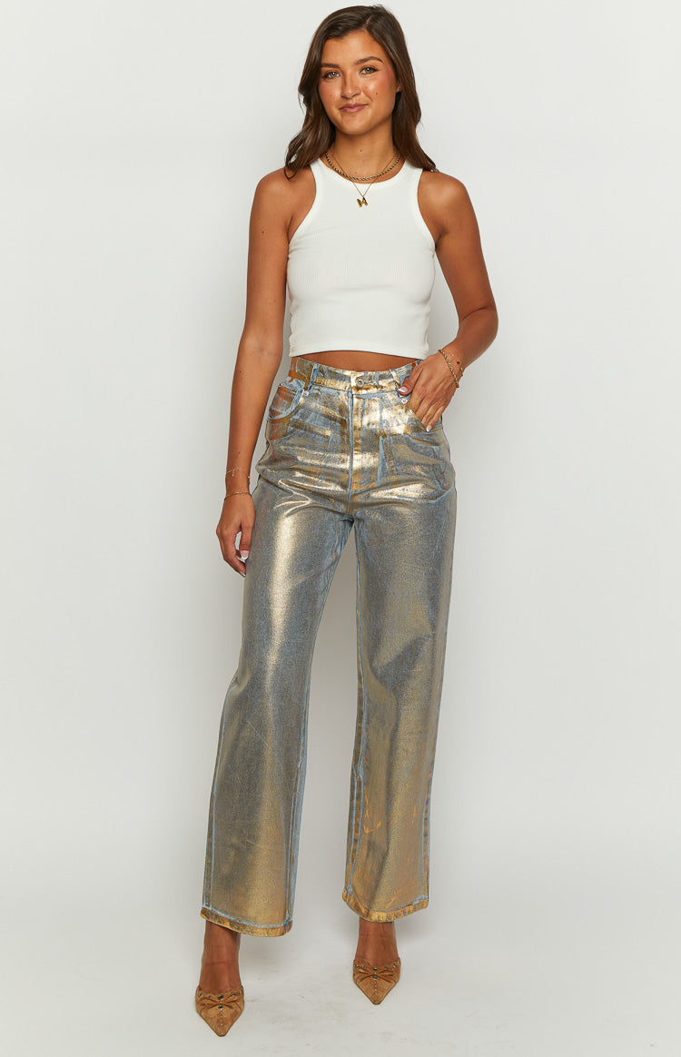 Full length front view of metallic gold and silver wide-leg jeans with a high waist and textured finish